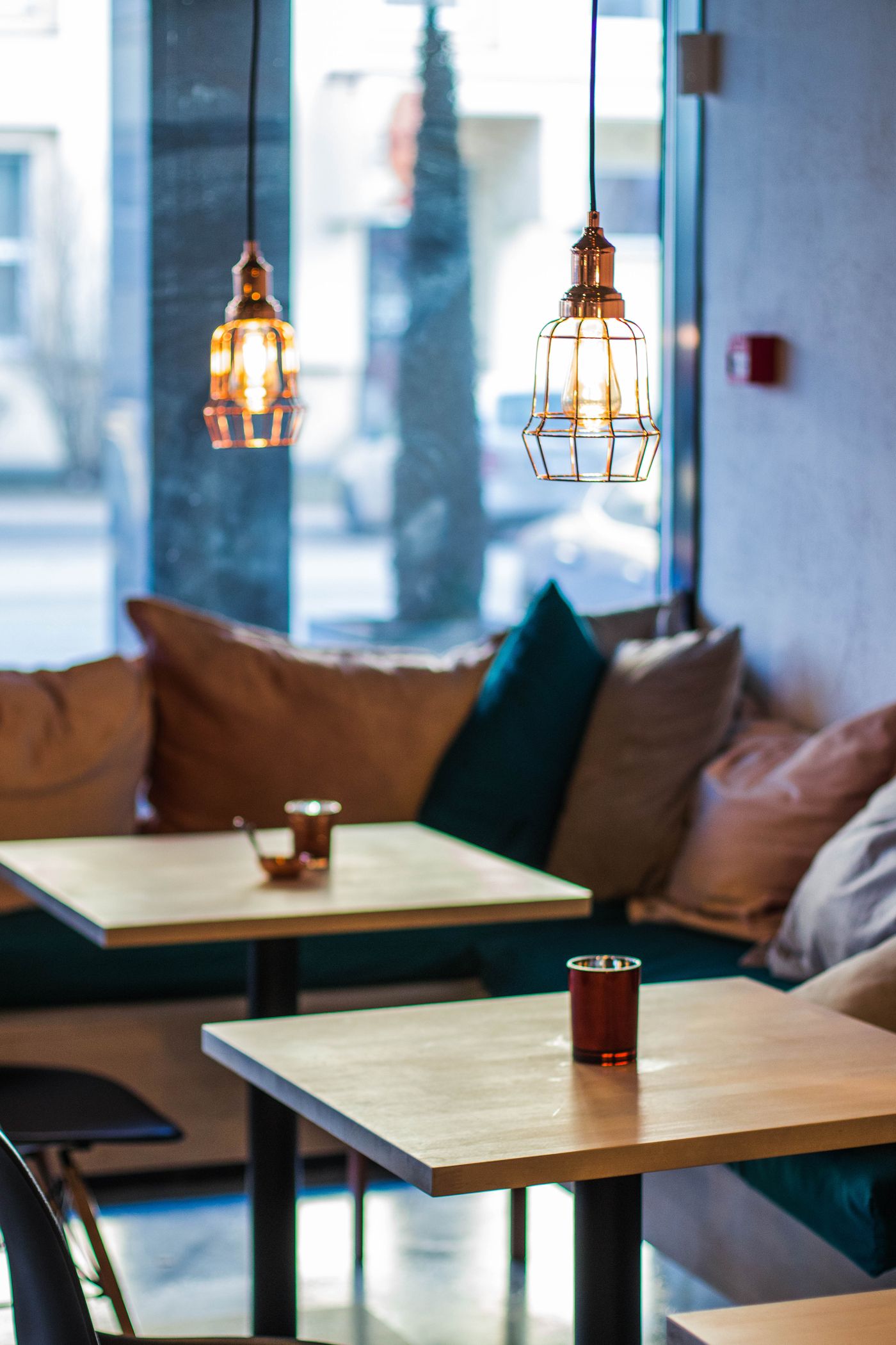 Cafe interior with copper pendant light fixtures installed over seating