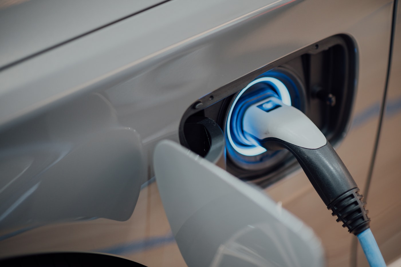 Electric vehicle plugged in and charging at a home charging station